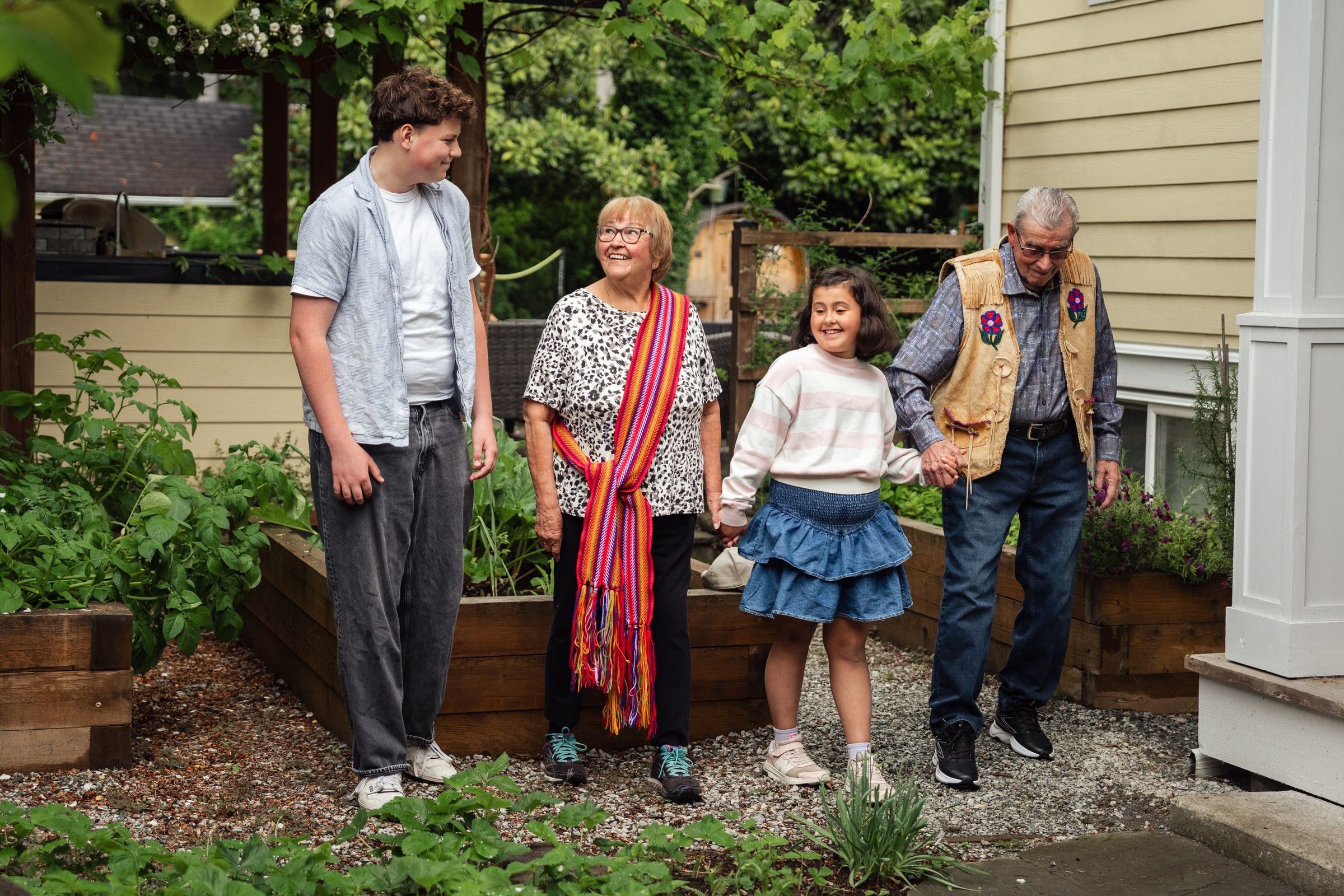 Three generations of a family in a garden